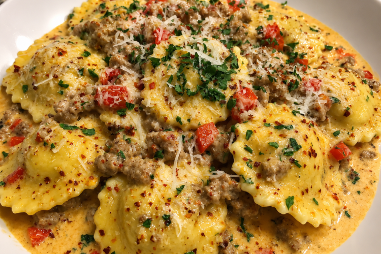 Creamy Cajun Sausage Ravioli made with tender cheese-filled ravioli, spicy Italian sausage, red and green bell peppers, onions, and garlic in a rich Parmesan Cajun cream sauce, garnished with freshly grated Parmesan and parsley. A hearty, restaurant-style pasta dinner that's perfect for weeknights or cozy family meals.