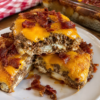 A hearty Bacon Cheeseburger Grilled Cheese Casserole made with buttery toasted bread, seasoned ground beef, crispy bacon, cheddar, mozzarella, and a creamy burger-inspired spread. The ultimate comfort food for family dinners and game nights.