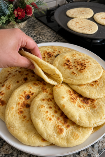 Incredibly soft, pillowy flatbread made on the stovetop in minutes. No long kneading or rising required—just mix, rest, roll, and cook until golden and puffed.