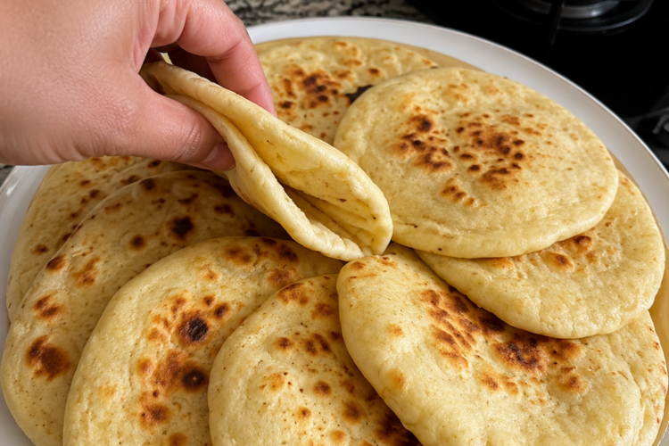 Incredibly soft, pillowy flatbread made on the stovetop in minutes. No long kneading or rising required—just mix, rest, roll, and cook until golden and puffed.