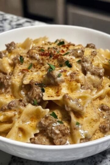 A rich and creamy one-pan pasta made with seasoned ground beef, garlic, Parmesan cheese, and tender bowtie pasta. The perfect comfort food for busy weeknights.