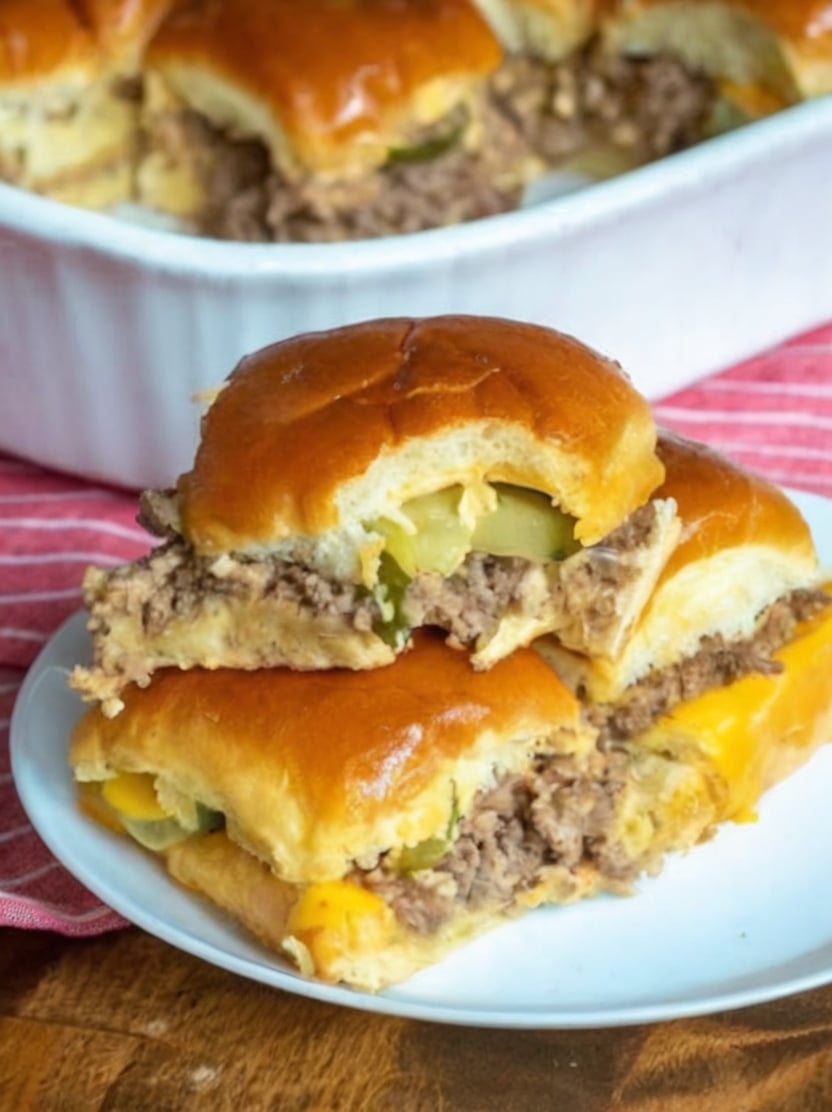 Tender seasoned ground beef layered with melted cheese and tangy pickles inside buttery baked slider buns for the ultimate easy family dinner.