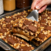 Caramel Chocolate Crunch Bars stacked on a serving plate, featuring a buttery shortbread crust, gooey caramel filling, rich melted chocolate, crunchy toasted pecans, and a sprinkle of flaky sea salt, perfect homemade American dessert.