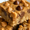 Peanut butter butterscotch bars with soft chewy centers, golden edges, glossy butterscotch chips, optional melted chocolate chips, and rich peanut butter flavor.