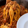 Homemade spaghetti with rich meat sauce served from a pot, featuring tender pasta coated in savory ground beef tomato sauce for a classic comfort food dinner