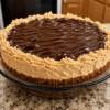 No-Bake Chocolate Peanut Butter Cream Pie with a buttery graham cracker crust, fluffy peanut butter cream filling, and a smooth, glossy chocolate ganache topping. This rich, creamy homemade dessert is chilled to perfection and garnished with chocolate shavings and peanut butter cups, making it an irresistible treat for holidays, parties, or summer gatherings.