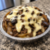 A hearty Keto Mushroom Swiss Burger Bowl filled with juicy seasoned ground beef, buttery caramelized mushrooms, and melted Swiss cheese, topped with crisp pickles and fresh lettuce in a rustic bowl. This low-carb burger bowl is a comforting, protein-packed meal that's perfect for a quick weeknight dinner or easy keto meal prep.