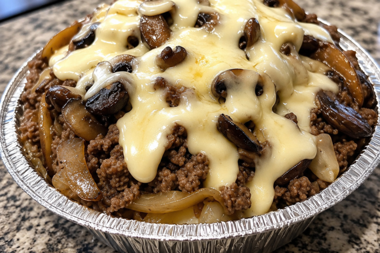 A hearty Keto Mushroom Swiss Burger Bowl filled with juicy seasoned ground beef, buttery caramelized mushrooms, and melted Swiss cheese, topped with crisp pickles and fresh lettuce in a rustic bowl. This low-carb burger bowl is a comforting, protein-packed meal that's perfect for a quick weeknight dinner or easy keto meal prep.