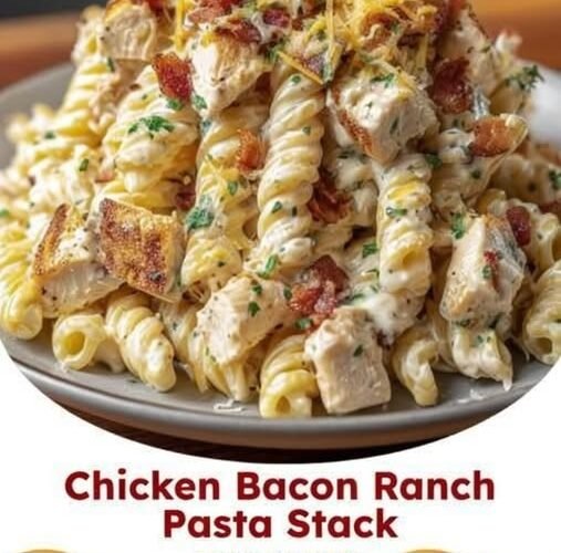 Creamy chicken bacon ranch pasta with tender chicken, crispy bacon, rotini pasta, melted cheddar cheese, and fresh parsley, served on a plate.