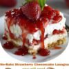 A no-bake strawberry cheesecake lasagna layered with a buttery graham cracker crust, creamy cheesecake filling, glossy strawberry topping, whipped cream, and fresh strawberries, served chilled in neat dessert squares.