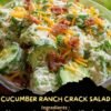 A creamy cucumber ranch salad with thinly sliced cucumbers, red onion, crispy bacon, shredded cheddar cheese, and fresh herbs, served chilled in a bowl.