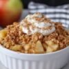 A warm cinnamon apple crisp made with tender sliced apples, topped with a golden, buttery oat crumble and lightly dusted with cinnamon.