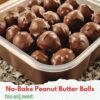 No-bake peanut butter balls coated in glossy chocolate, arranged closely together on a plate, with creamy peanut butter centers and a smooth chocolate shell.