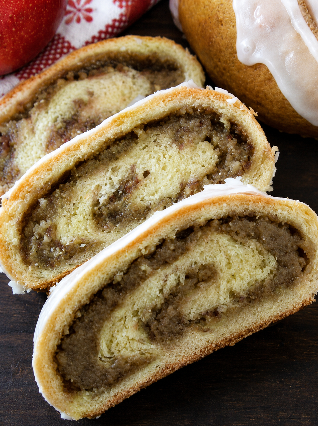 Hungarian nut rolls sliced open to reveal a sweet walnut-cinnamon filling inside soft, golden pastry, lightly glazed with icing.
