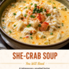 A rustic bowl of creamy she-crab soup filled with tender lump crabmeat, garnished with fresh chives and a light dusting of paprika. The rich, velvety soup is served with crusty artisan bread on the side, a spoon resting in the bowl, and warm natural lighting highlighting the silky texture on a wooden table for a cozy coastal comfort food presentation.
