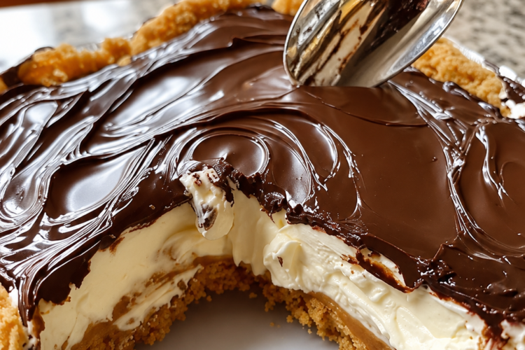 No-Bake Éclair Cake with layers of soft, cake-like graham crackers, creamy vanilla pudding filling, and a smooth rich chocolate frosting topping. The chilled dessert is sliced into neat squares, revealing the creamy layered center, and served as a nostalgic, chocolatey dessert perfect for potlucks and family gatherings.