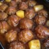 Sweet and savory slow cooker pineapple barbecue meatballs made with tender meatballs coated in tangy BBQ sauce, juicy pineapple chunks, brown sugar, and garlic. The meatballs are warm, glossy, and generously covered in the sweet-and-smoky sauce, making them an easy appetizer for parties, game day, or family gatherings.