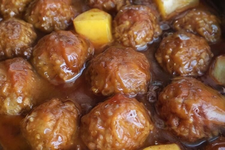Sweet and savory slow cooker pineapple barbecue meatballs made with tender meatballs coated in tangy BBQ sauce, juicy pineapple chunks, brown sugar, and garlic. The meatballs are warm, glossy, and generously covered in the sweet-and-smoky sauce, making them an easy appetizer for parties, game day, or family gatherings.