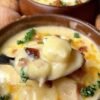 Creamy loaded baked potato soup made with tender cubed potatoes, whole milk, butter, flour, onion, sour cream, and shredded cheddar cheese. The soup has a thick, velvety texture and rich potato flavor, making it a warm and comforting one-pot meal.