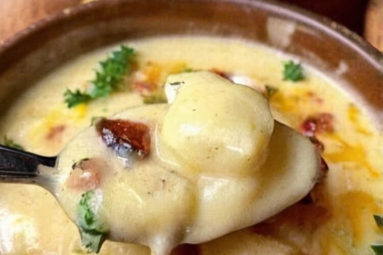 Creamy loaded baked potato soup made with tender cubed potatoes, whole milk, butter, flour, onion, sour cream, and shredded cheddar cheese. The soup has a thick, velvety texture and rich potato flavor, making it a warm and comforting one-pot meal.