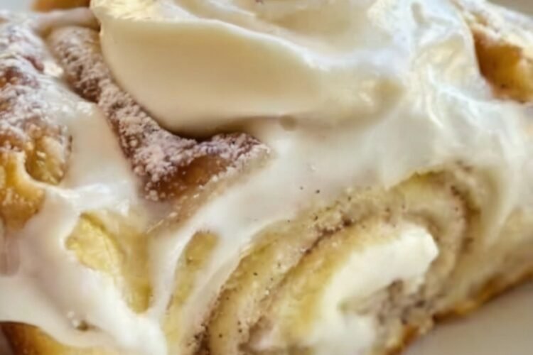 Banana Bread Cinnamon Rolls made with soft banana-infused dough, a buttery cinnamon-brown sugar filling, and creamy cream cheese frosting. The rolls are baked until golden and fluffy, then generously frosted while warm so the frosting melts into the cinnamon swirls, creating an indulgent breakfast or dessert.