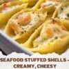 A close-up of creamy seafood stuffed shells filled with crab, shrimp, ricotta, and mozzarella, baked until golden and bubbly in a rich garlic Parmesan cream sauce, garnished with fresh parsley.