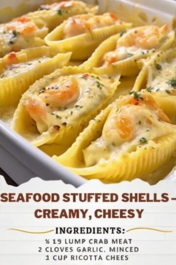 A close-up of creamy seafood stuffed shells filled with crab, shrimp, ricotta, and mozzarella, baked until golden and bubbly in a rich garlic Parmesan cream sauce, garnished with fresh parsley.