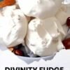 Homemade divinity fudge with a light, fluffy white texture, topped with chopped pecans and served as bite-sized holiday candy.
