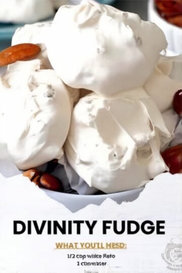 Homemade divinity fudge with a light, fluffy white texture, topped with chopped pecans and served as bite-sized holiday candy.