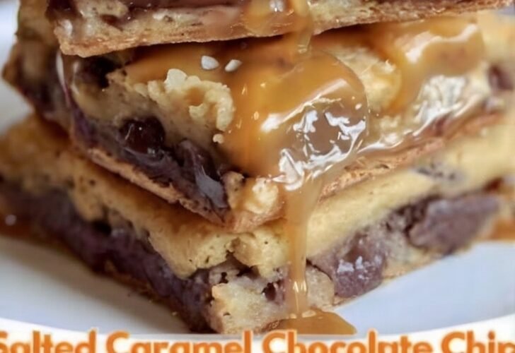 A tray of thick, fudgy chocolate brownies topped with a smooth, glossy chocolate icing that has set into a delicate crackly finish, cut into neat squares and ready to serve.
