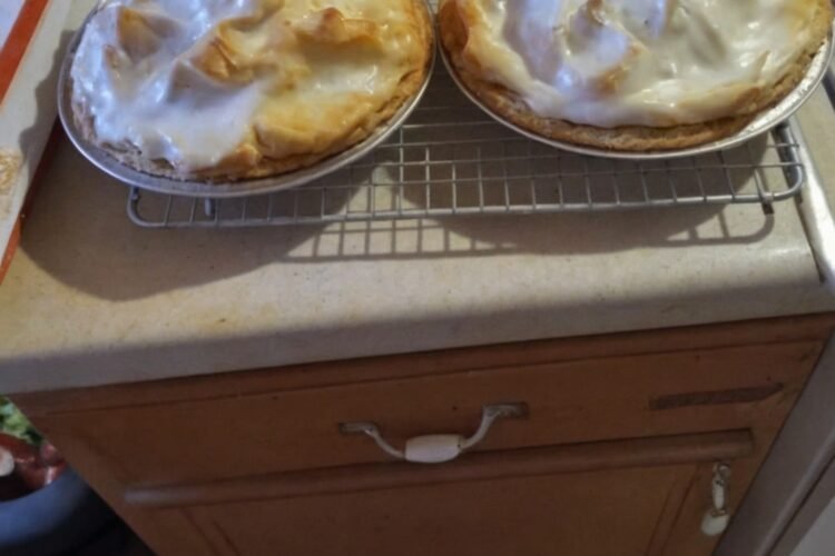A classic homemade chocolate cream pie with a rich, smooth chocolate filling in a flaky crust, topped with a generous layer of golden-brown meringue.