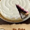 No-bake blueberry cream pie with a graham cracker crust, creamy white cheesecake filling, and glossy blueberry topping swirled across the surface, with one slice removed.