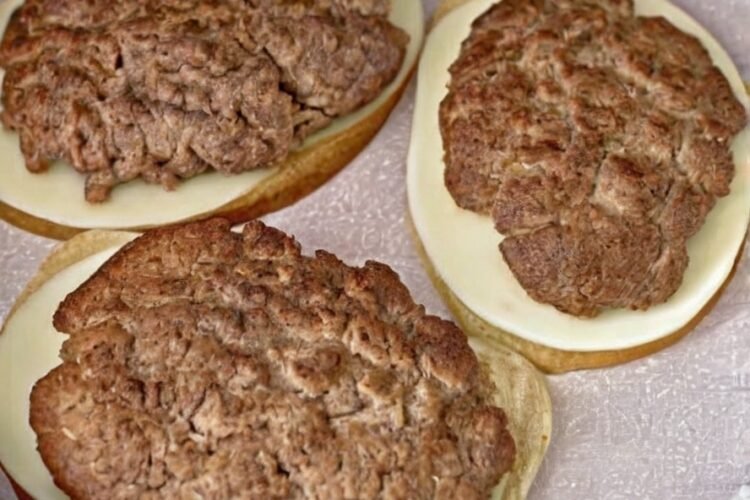 A classic patty melt made with a juicy seasoned beef patty, melted cheddar and provolone cheese, and crispy golden-brown rye bread, served with a creamy bacon secret sauce.