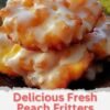 A plate of golden-brown peach fritters with crisp, craggy edges and soft centers filled with juicy peach pieces, generously drizzled with a sweet vanilla glaze.