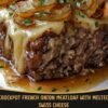 Crockpot French Onion Meatloaf with melted Swiss cheese, caramelized onions, savory onion gravy, and fresh parsley, served as a thick, tender slice on a plate.