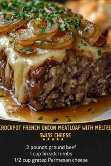 Crockpot French Onion Meatloaf with melted Swiss cheese, caramelized onions, savory onion gravy, and fresh parsley, served as a thick, tender slice on a plate.