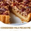 A homemade pecan pie with a golden, flaky crust, rich silky caramel-like filling, and a glossy layer of toasted pecan halves arranged across the top.