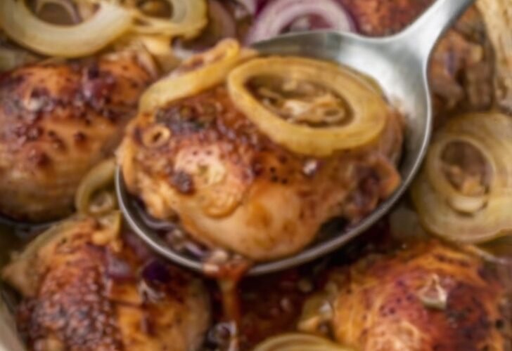 Juicy baked chicken thighs served over tender caramelized sweet onion rings, coated in a glossy savory-sweet sauce. A simple 3-ingredient chicken dinner in a white baking dish.