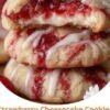 Soft strawberry cheesecake cookies with a golden sugar-cookie exterior, creamy sweet-tangy cream cheese filling, and a pocket of strawberry jam in the center. The cookies are drizzled with a smooth white vanilla glaze for a bakery-style finish.