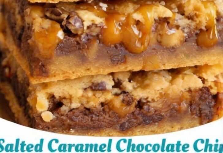 Stacked salted caramel chocolate chip cookie bars with a chewy golden cookie base, melted chocolate chips, gooey caramel drizzle, and flaky sea salt on top.