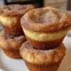 Soft, golden cinnamon sugar donut muffins with buttery tops, freshly baked and coated in sweet cinnamon sugar.