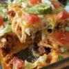 Cheesy taco bake made with golden crescent roll dough, seasoned ground beef, melted cheddar cheese, shredded lettuce, and diced tomatoes.