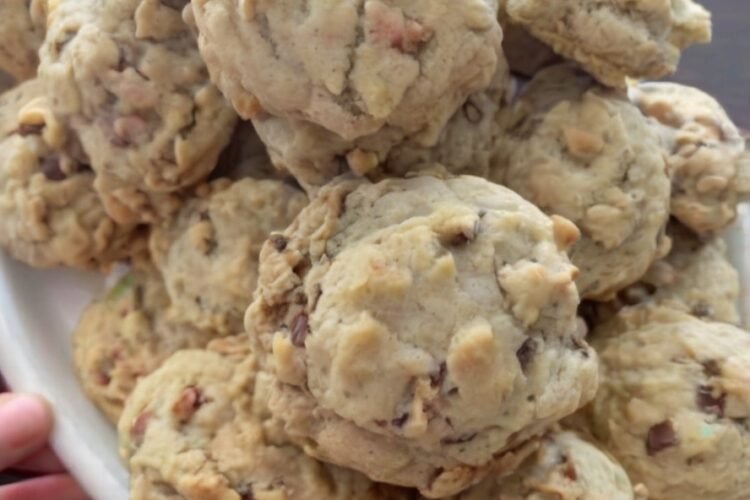Buttery pecan cookies with a delicate, crumbly shortbread-like texture and toasted chopped pecans throughout. The cookies are lightly golden on the bottoms, pale on top, and dusted generously with powdered sugar for a classic melt-in-your-mouth finish.