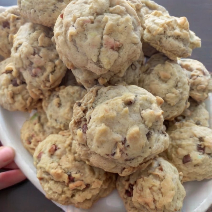 Buttery pecan cookies with a delicate, crumbly shortbread-like texture and toasted chopped pecans throughout. The cookies are lightly golden on the bottoms, pale on top, and dusted generously with powdered sugar for a classic melt-in-your-mouth finish.