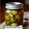 A jar of pickled Brussels sprouts, packed in a tangy-looking brine with mustard seeds and labeled “Pickled Frog Balls,” with a few fresh Brussels sprouts beside the jar. delish.com
