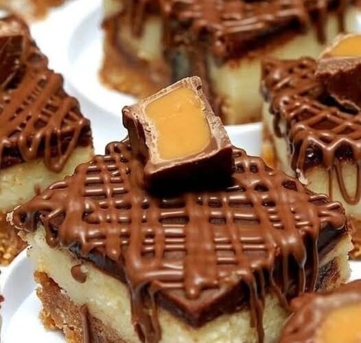 Decadent Rolo cheesecake bars with a buttery graham cracker crust, creamy cheesecake center, rich chocolate topping, and Rolo candies with gooey caramel centers on top.
