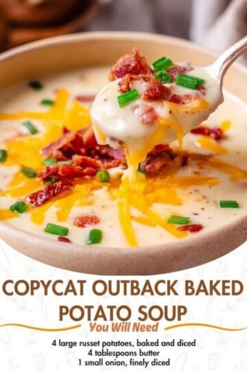 A creamy loaded baked potato soup topped with melted cheddar cheese, crispy bacon pieces, and fresh green onions, with a spoonful being lifted to show its rich, velvety texture.