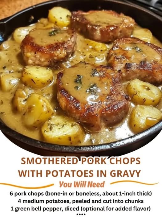 A comforting skillet of golden-browned smothered pork chops nestled among tender potatoes and coated in a rich, savory herb gravy.
