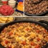 A hearty cheesy ground beef and rice skillet loaded with seasoned beef, tender rice, tomatoes, and green chiles, all topped with a generous layer of melted cheddar cheese.