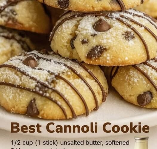 Soft, golden cannoli cookies studded with chocolate chips, dusted with powdered sugar, and finished with delicate drizzles of melted chocolate.